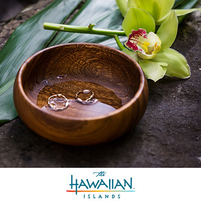Rings in a wooden bowl with orchid