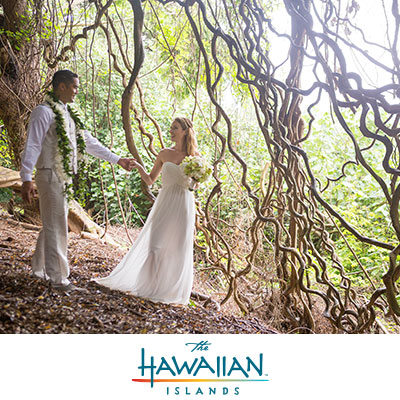 Bride and Groom walking through tree vines