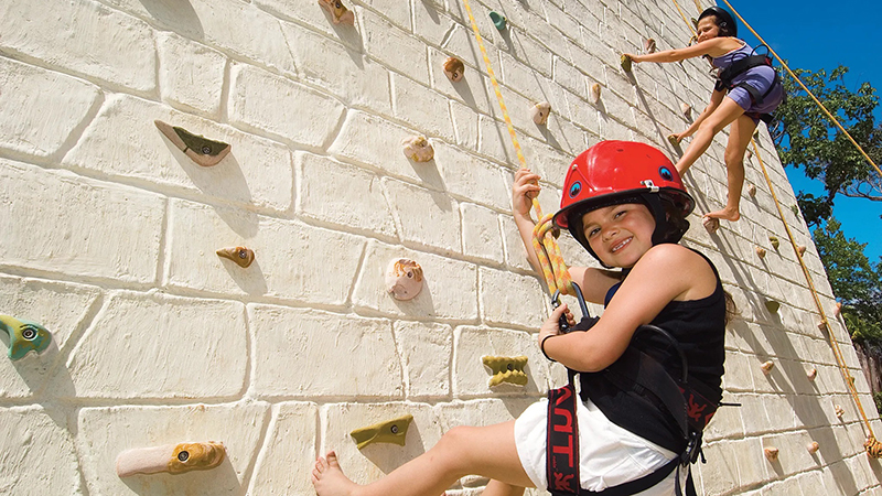 Kids on rock climbing wall at Dreams Tulum