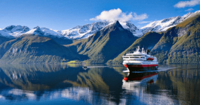 Hurtigruten ship on the Norwegian coast with mountains in the background