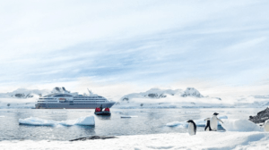Ponant cruise ship in Antarctica with glaciers and penguins