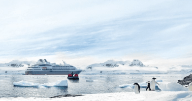 Ponant cruise ship in Antarctica with glaciers and penguins