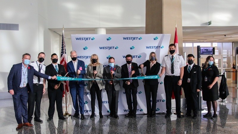 WestJet YYC-SEA inaugural ribbon cutting with, Richard Bartrem, John Fleming, Cindy Ady, Tim Patterson, Roger Reid, Carmelle Hunka and WestJet Crew of flight WS3612.