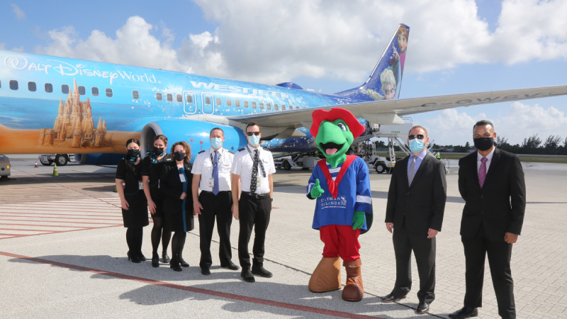 Left to right: WestJet flight crew; Sir Turtle of the Cayman Islands; Chief Officer Stran Bodden, Ministry of Tourism and Transport; and Gary Hendricks-Dominguez, Deputy Director of International Marketing and Promotions.