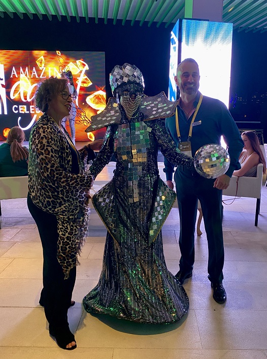 Manon Langelier, Reg Leisure Sales Manager at Les Voyages Laurier Du Vallon Quebec and Mark Benson Senior Director Sales Strategy AMResorts with Disco Ball performer.