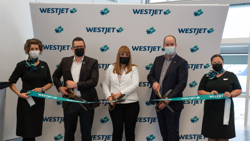 WestJet celebrates inaugural flight from YYC to LHR. Left to right: WestJet Cabin Crew employee; Chris Hedlin, VP Network & Alliances; Colleen Tynan, VP Airports; Chris Miles, VP Operations and Infrastructure, Calgary Airport Authority; and another WestJet Cabin Crew employee.