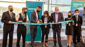 Jared Mikoch-Gerke, WestJet, Director, Government Relations and Regulatory Affairs (third from left); Janik Reigate, Greater Toronto Airport Authority, Director, Strategic Customer Relationships (middle); Gary Cox, Government of Scotland, Head of Aviation (third from right), and crew members inaugurate WestJet's new YYZ-EDI service.