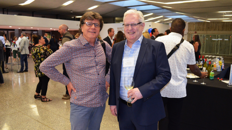 Paul Larcher, Account Director, The Palm Beaches, represented by Vox International (left) and event guest.
