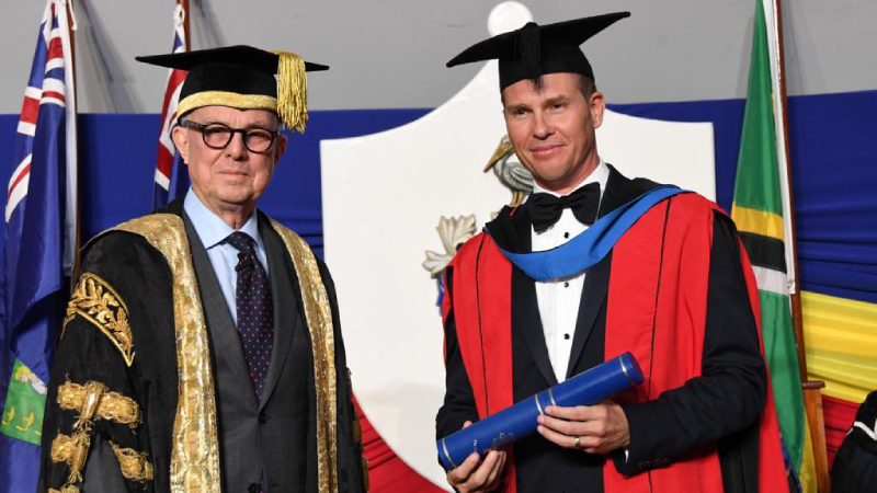 Sandals Resorts International Executive Chairman Adam Stewart (right) receiving his honourary Doctor of Laws (LLD) degree at the 2022 graduation ceremony of The University of the West Indies (The UWI).