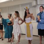 GO s, dressed as famous women in history, welcoming GM s into dinner